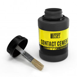 Container of contact cement with a brush on a white background