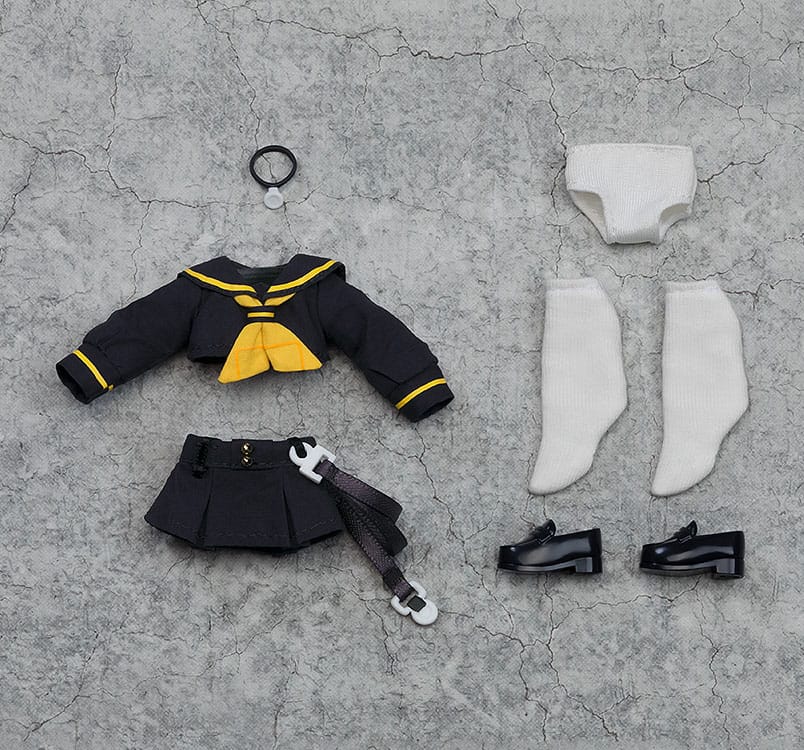 Toy outfit pieces including a jacket, skirt, shoes, and accessories on a textured gray surface.