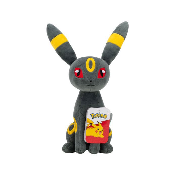 Plush toy of a gray creature with red eyes and yellow accents, holding a Pokémon Pikachu card on a white background.