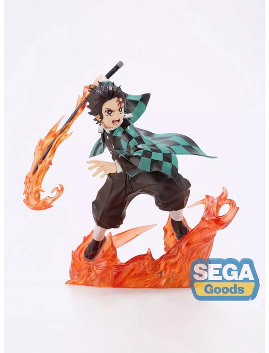 A collectible anime figure of Tanjiro Kamado from Demon Slayer, posed dynamically on a flame-shaped base with a floating flame effect, featuring a SEGA Goods logo overlay in the bottom right corner.