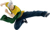 A dynamic anime figurine of a martial artist in mid-air kick, wearing a yellow shirt, green sash, and dark blue pants, isolated on a white background.