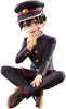 A collectible anime figurine of a character in a dark uniform with gold buttons and red trim, seated in a crouched pose against a plain white background.