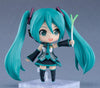 Anime character figurine with teal hair and outfit on a gray background