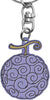 A One Piece anime keychain featuring the Black Court Fruit (Chop Suey) design. The keychain has a silver metal split ring and clasp, with a purple fruit charm decorated with black swirl patterns and a gold-colored stem.
