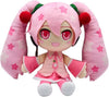 A pink anime-style plush doll with long twin-tail pigtails, large red eyes, and a pink outfit with white stars, shown on a plain white background.