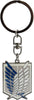 Attack on Titan keychain featuring the Survey Corps emblem with blue and silver wings on a white shield, attached to a silver clasp and black split ring.