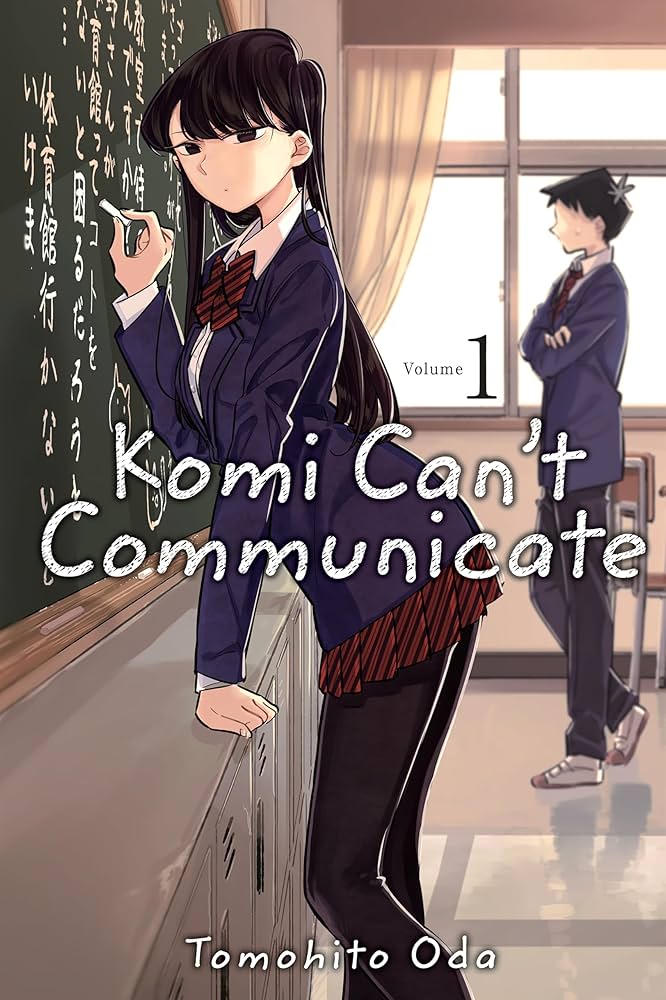 Illustrated book cover for 'Komi Can't Communicate' Volume 1 by Tomohito Oda, showing an anime-style girl in a school uniform standing by a chalkboard in a classroom, with another student in the background.