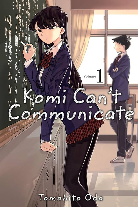 Illustrated book cover for 'Komi Can't Communicate' Volume 1 by Tomohito Oda, showing an anime-style girl in a school uniform standing by a chalkboard in a classroom, with another student in the background.