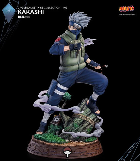 A detailed collectible figurine of Kakashi Hatake from Naruto, posed dynamically on a decorative tree stump base with swirling smoke effects. The figure is dressed in his signature blue and green ninja attire, standing on a brown carved base against a solid black background.
