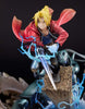 Figurine of a character with blonde hair and red cloak holding a sword on a dark background