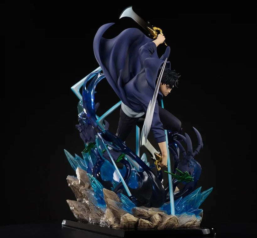 A detailed anime action figure of a character in a dynamic pose, wearing a dark blue cloak and black outfit, holding a large silver sword, set on a rocky base with blue energy effects against a black background.
