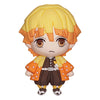 Small figurine with blonde hair and orange outfit on a white background