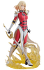 A detailed anime figurine of a blonde female warrior in a red, white, and black bodysuit, holding a large gold-colored sword and standing on a golden flame-like base against a plain white background.