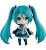 A chibi-style vinyl figure of Hatsune Miku with long turquoise twin tails, a black and teal outfit, and dark boots, shown against a plain white background.