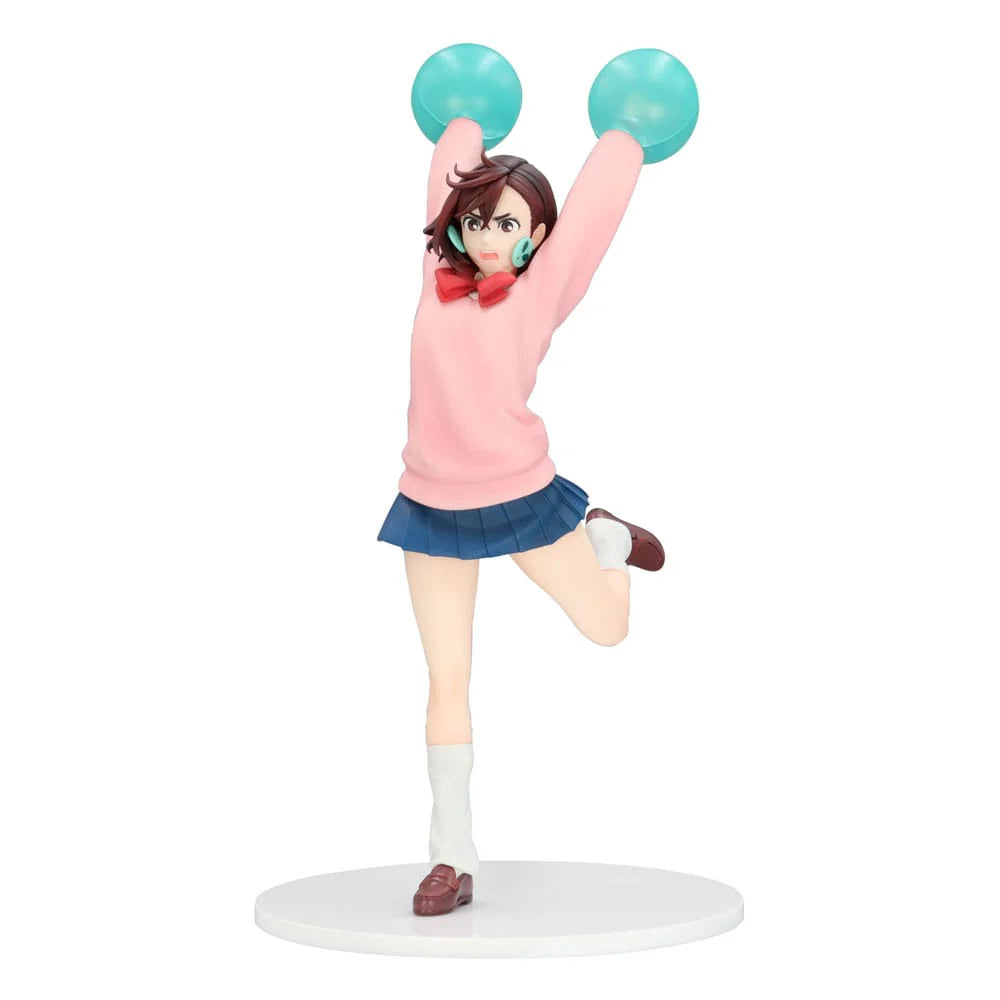 Figurine of an animated character in a pink sweater and blue skirt with green pom-poms on a white background