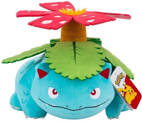 A blue plush toy resembling Bulbasaur from Pokémon, with a green leaf on its back and a red flower growing from it. A Pokémon tag is attached on the right side, set against a plain white background.