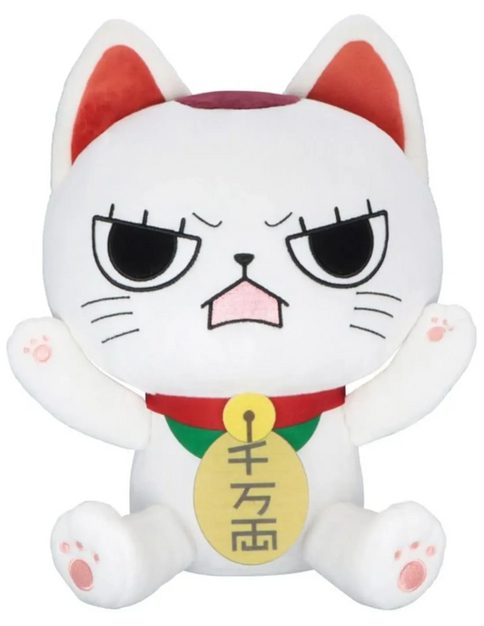 A white plush toy cat with an angry or skeptical expression, featuring red inner ears, a red collar, a green accent, and a yellow bell with Japanese characters.