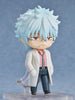 Anime character figurine with light blue hair and a white lab coat on a gray background