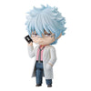 Anime character figurine with blue hair and glasses holding a phone on a white background