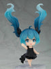 Figurine with blue hair and a black dress on a gray background