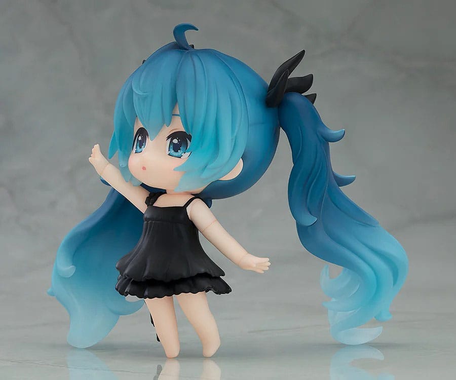 Figurine with blue hair and a black dress on a gray background