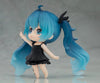 Figurine with blue hair and a black dress on a gray background