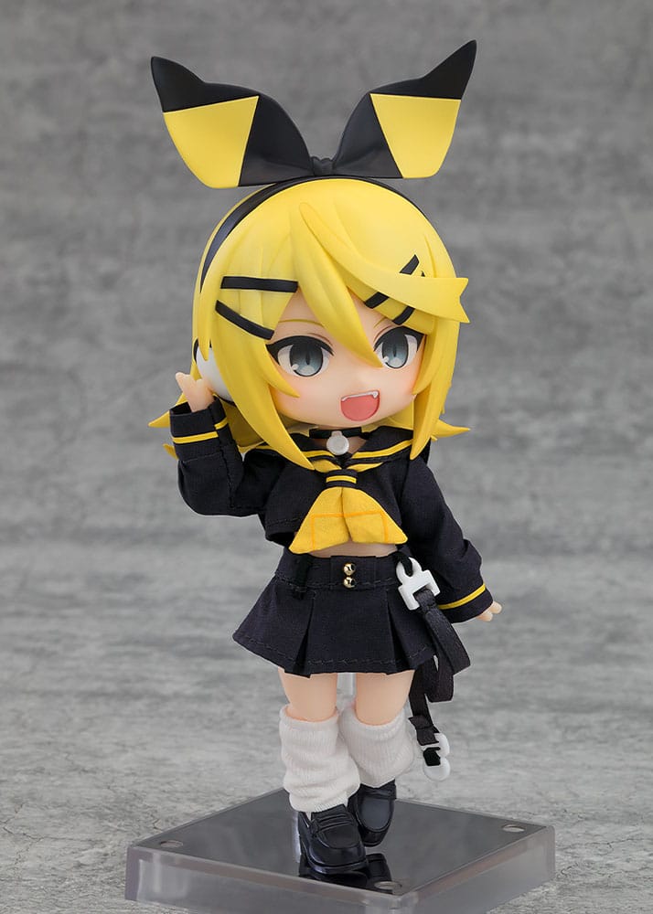 Anime character figurine with yellow hair and black outfit on a gray background