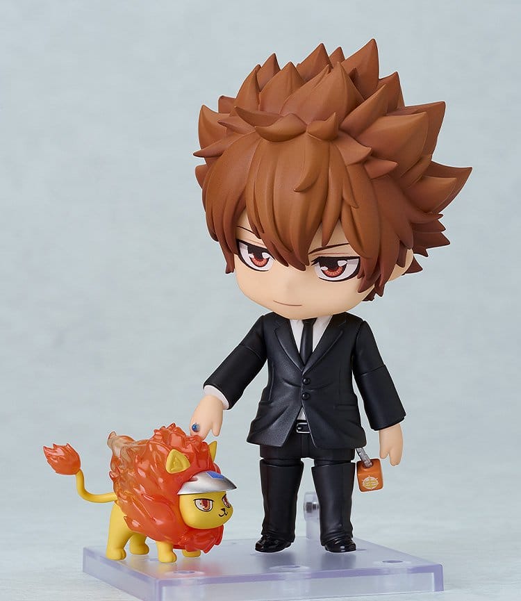 Figurine of a character in a suit with a small lion-like creature on a light gray background