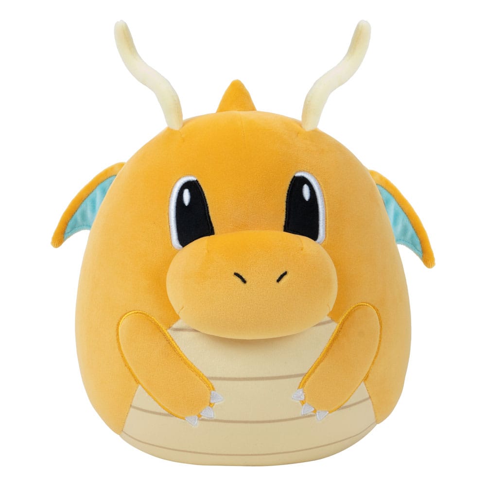 Plush toy resembling a dragon with a yellow body and black eyes on a white background