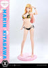 A full-body anime figurine of Marin Kitagawa wearing a black bikini with yellow floral print, standing on a pink round base against a light gray studio background. A pink vertical banner on the left reads 'MARIN KITAGAWA' with branding at the bottom.