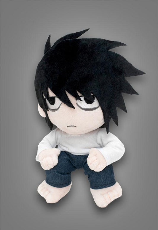 Plush toy with spiky black hair and white face on a gray background